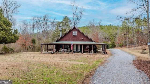 view of front facade with a front yard and covered porch