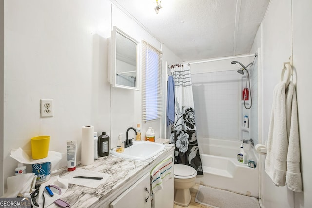 full bathroom with vanity, a textured ceiling, toilet, and shower / bath combo with shower curtain