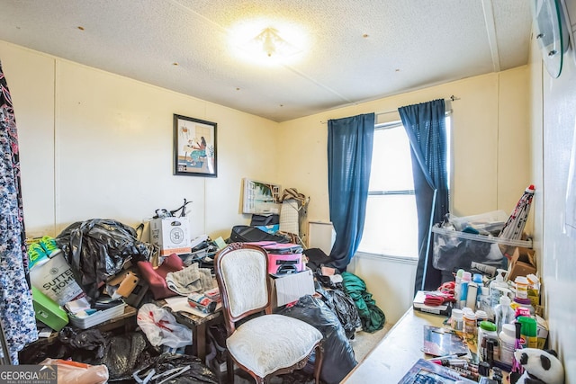 miscellaneous room with a textured ceiling