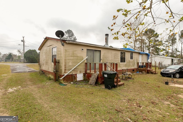 rear view of house with a yard