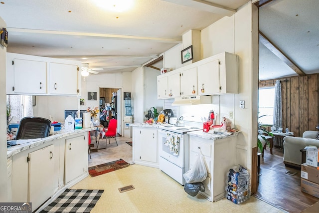 kitchen with electric stove, vaulted ceiling with beams, white cabinets, and ceiling fan