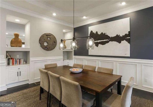 dining room with ornamental molding and dark hardwood / wood-style flooring