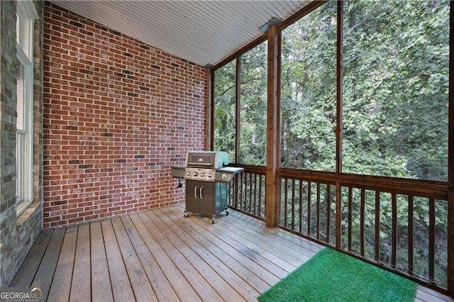 unfurnished sunroom featuring vaulted ceiling