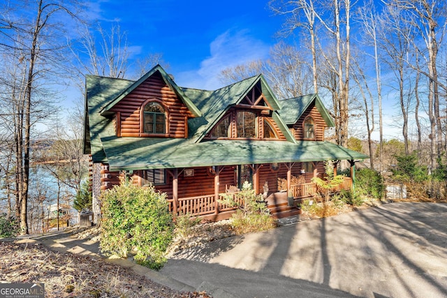 log home featuring covered porch