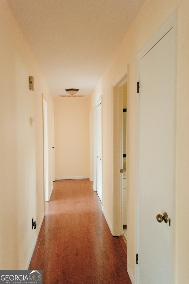 hall with wood-type flooring