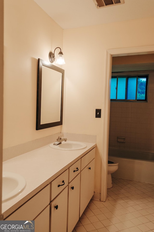 bathroom with tile patterned floors, vanity, and toilet