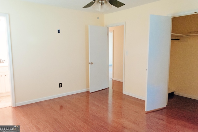 unfurnished bedroom with hardwood / wood-style flooring and a closet