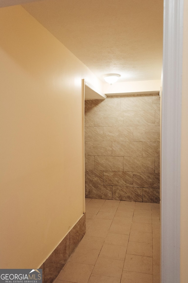 hallway featuring light tile patterned floors