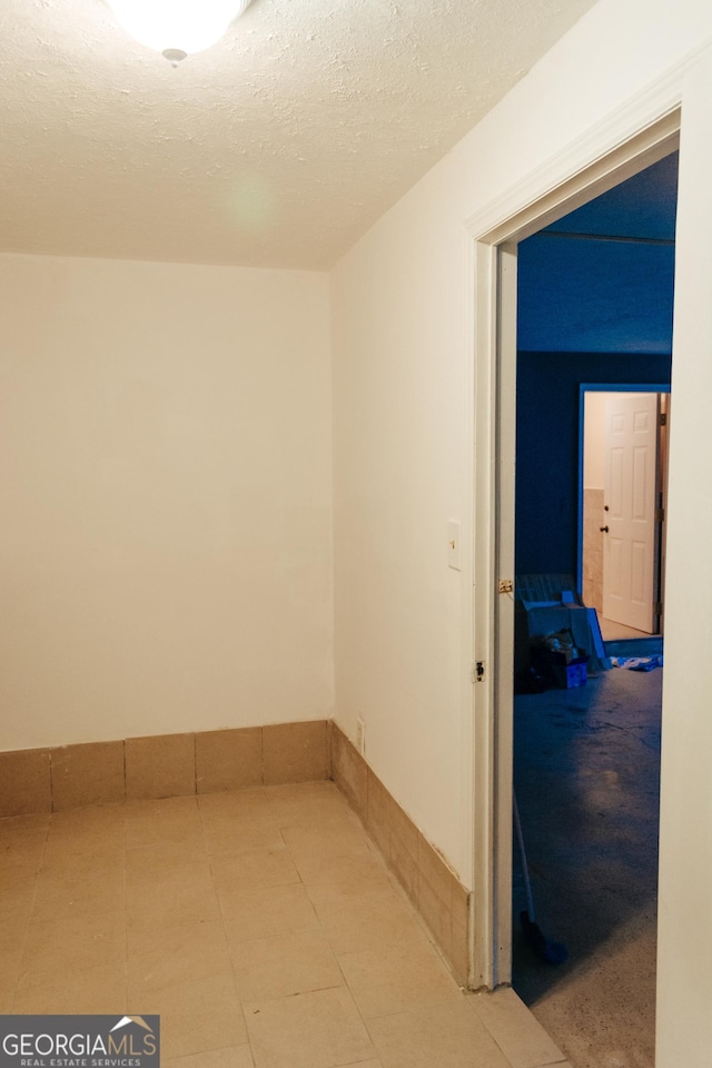 hallway featuring a textured ceiling