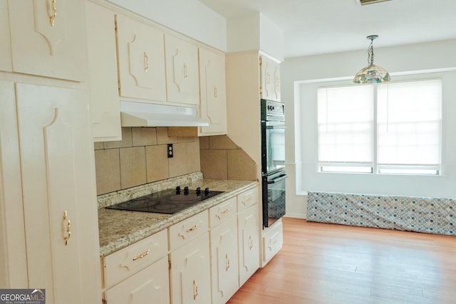 kitchen featuring white cabinets, a healthy amount of sunlight, decorative light fixtures, and black appliances