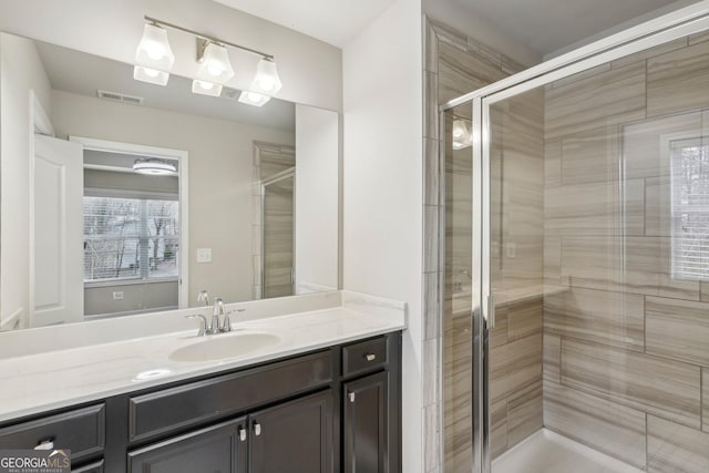 bathroom featuring vanity and an enclosed shower