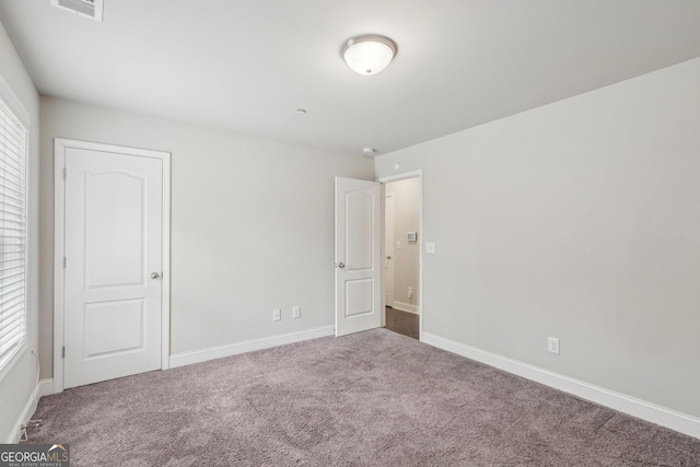 unfurnished room featuring carpet flooring