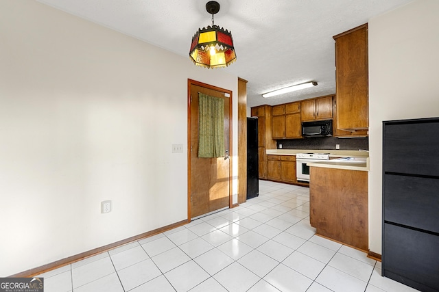 kitchen featuring light tile patterned floors, decorative light fixtures, black appliances, and sink