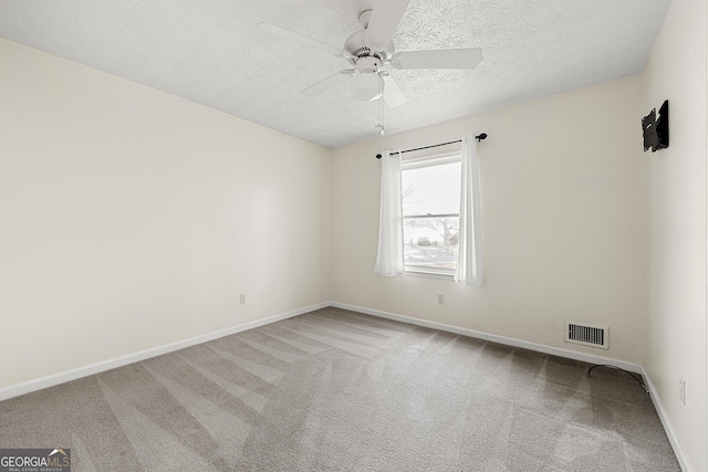 empty room with carpet, a textured ceiling, and ceiling fan