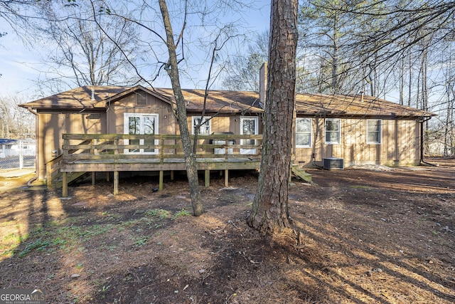 rear view of property featuring central air condition unit and a deck