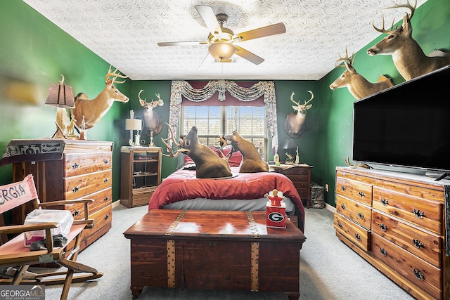 bedroom with a textured ceiling, carpet flooring, and baseboards