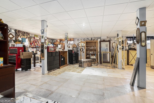 interior space featuring a paneled ceiling and a workshop area