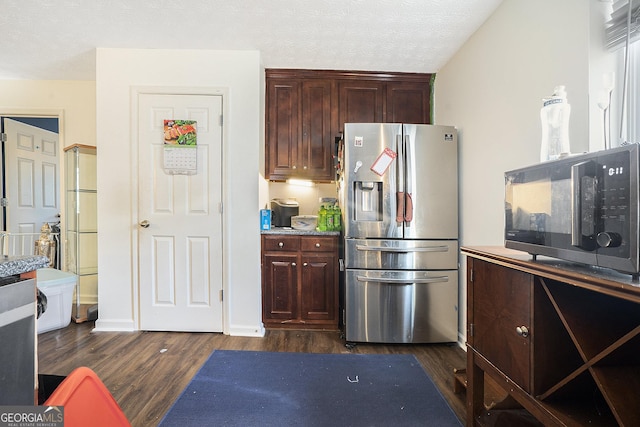 kitchen with a textured ceiling, dark wood-type flooring, and stainless steel refrigerator with ice dispenser