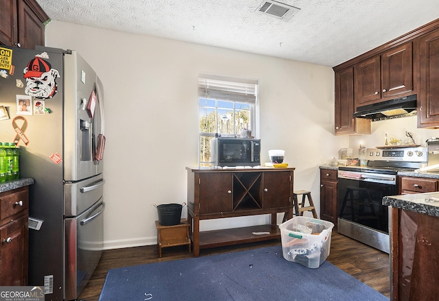 kitchen with dark wood-style floors, visible vents, appliances with stainless steel finishes, a textured ceiling, and under cabinet range hood