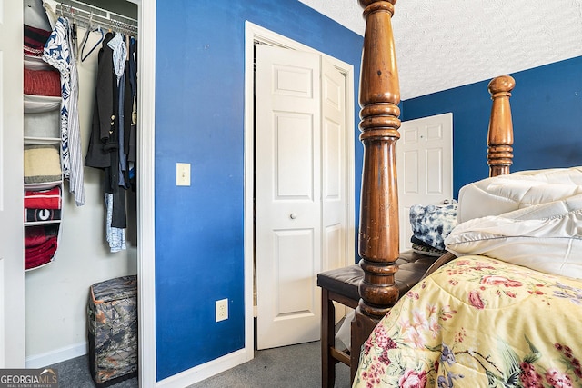 bedroom with carpet, a closet, baseboards, and a textured ceiling