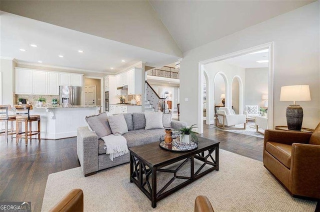 living room with hardwood / wood-style flooring and high vaulted ceiling