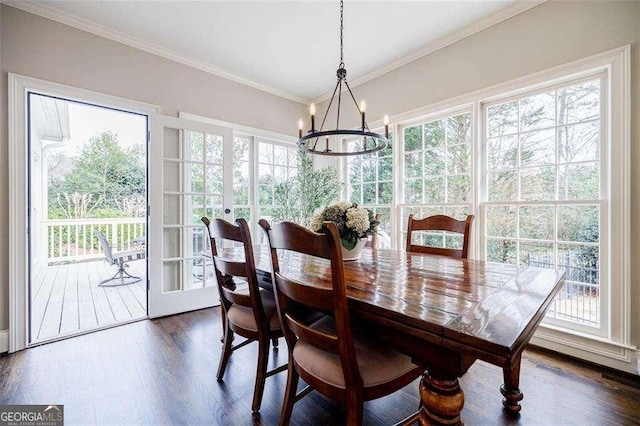 dining room with dark wood-type flooring, crown molding, and a chandelier