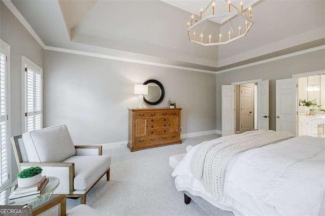 bedroom with ensuite bathroom, crown molding, an inviting chandelier, light carpet, and a raised ceiling