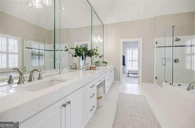 bathroom featuring walk in shower, vanity, a chandelier, and tile patterned flooring