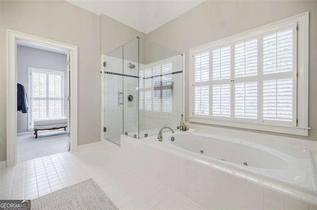 bathroom featuring tile patterned flooring and independent shower and bath