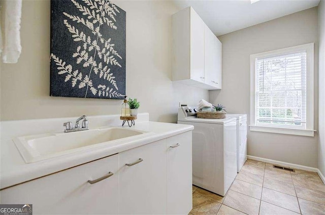 laundry room with cabinets, sink, independent washer and dryer, and light tile patterned flooring