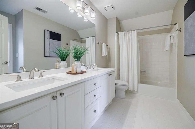 full bathroom featuring vanity, toilet, tile patterned flooring, and shower / bath combo