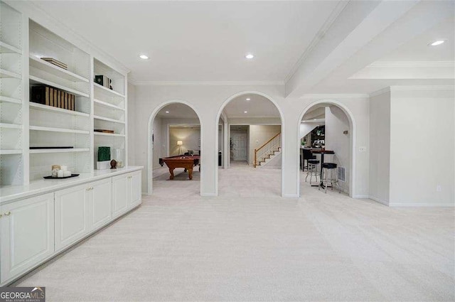 corridor featuring light carpet and crown molding