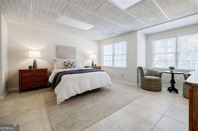 tiled bedroom with a paneled ceiling