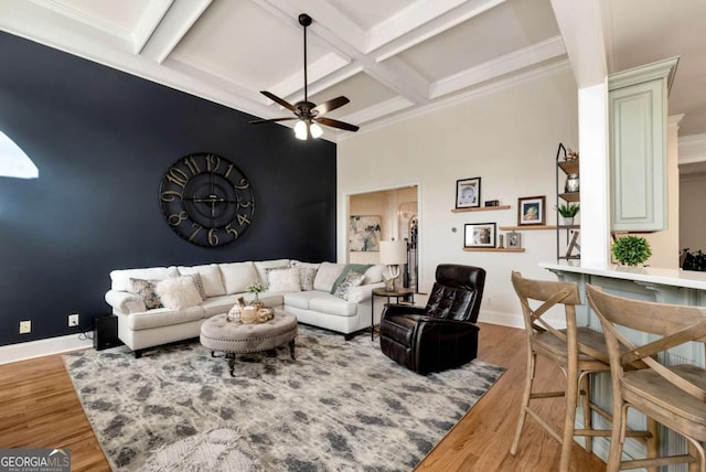 living room featuring beam ceiling, coffered ceiling, hardwood / wood-style floors, and ceiling fan