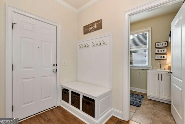 mudroom featuring sink and crown molding