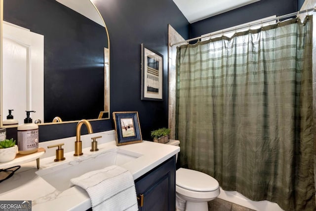 full bathroom featuring vanity, shower / tub combo, and toilet