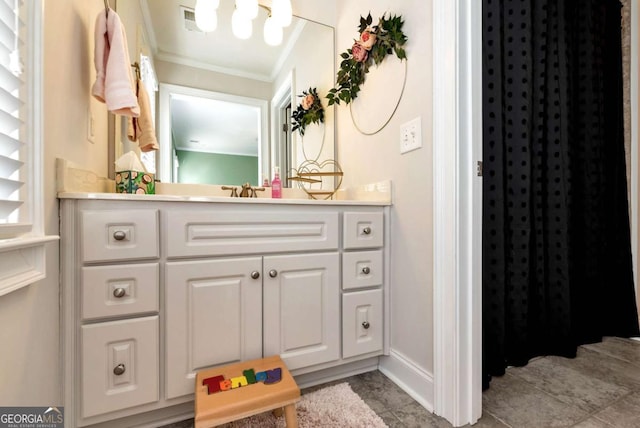 bathroom featuring ornamental molding and vanity