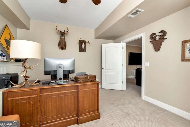 carpeted office space featuring ceiling fan