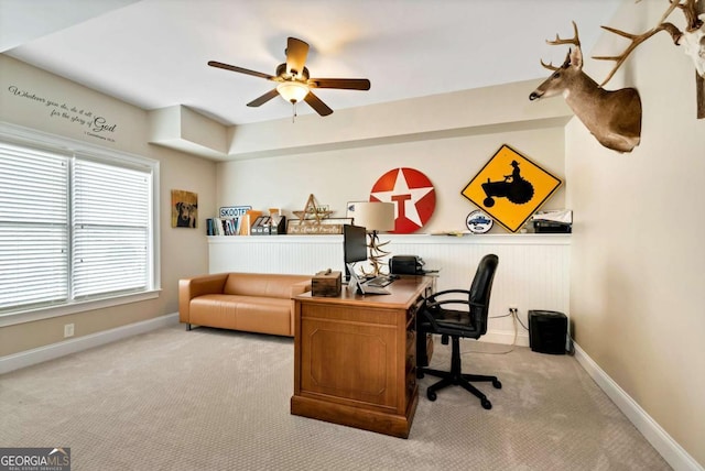 office area featuring light carpet and ceiling fan