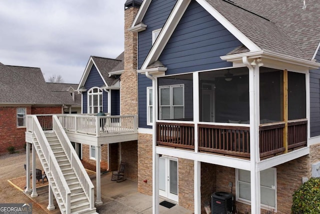 rear view of house with a patio, a sunroom, and cooling unit