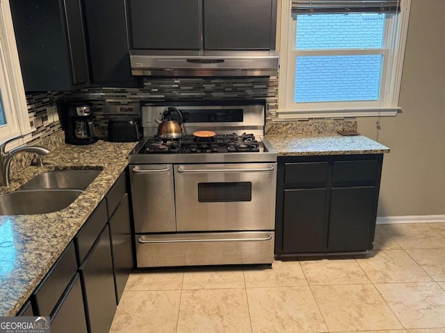 kitchen with light tile patterned flooring, tasteful backsplash, sink, double oven range, and light stone counters