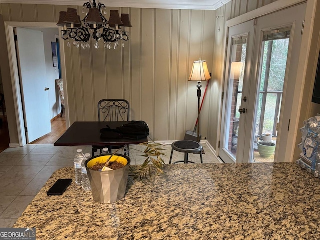 dining room with crown molding, french doors, a chandelier, and light tile patterned flooring