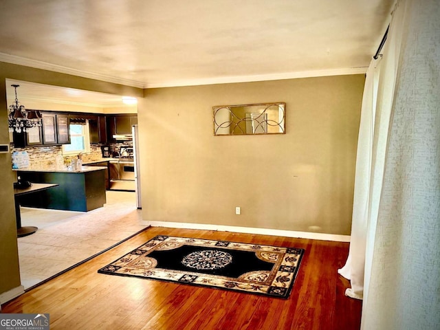 interior space with crown molding, dark wood-type flooring, and an inviting chandelier