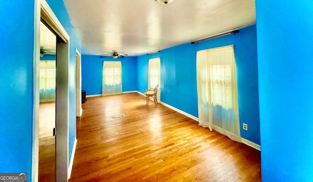 empty room featuring ceiling fan and wood-type flooring