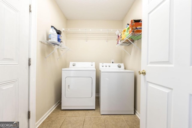 washroom with light tile patterned floors and independent washer and dryer