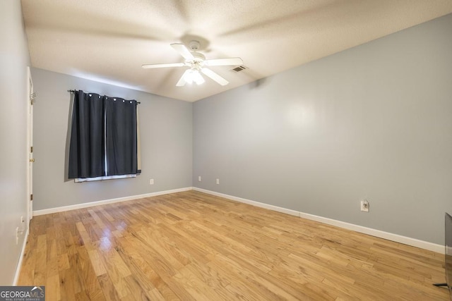 spare room featuring ceiling fan and light wood-type flooring