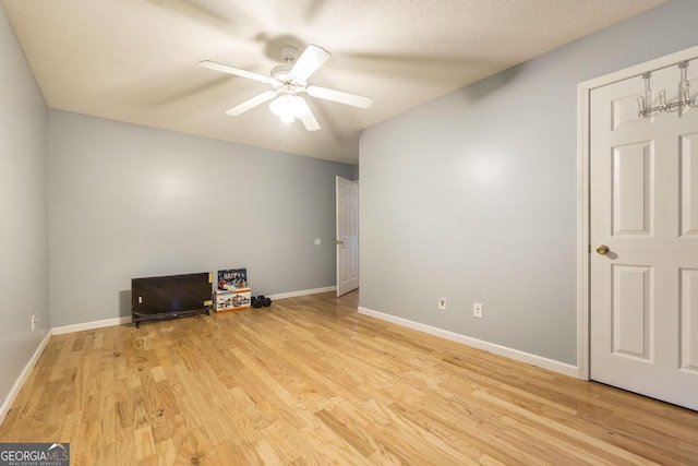 unfurnished room with ceiling fan and light hardwood / wood-style floors