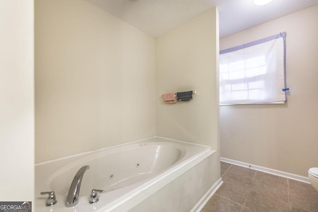 bathroom with toilet, tile patterned flooring, and a bathtub