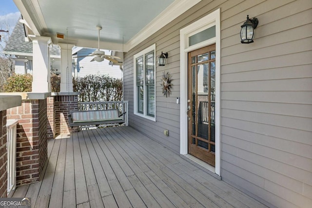 wooden deck featuring ceiling fan and a porch