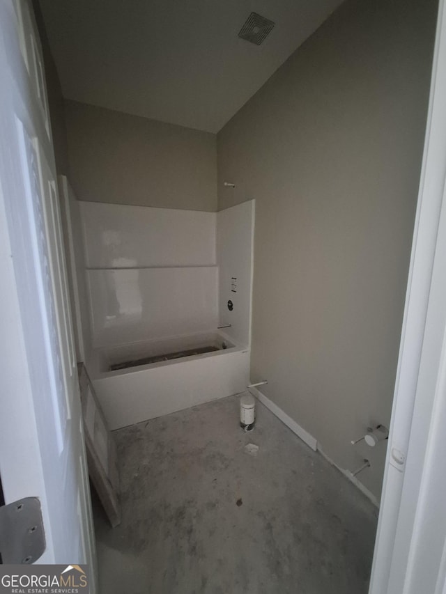 bathroom featuring washtub / shower combination, visible vents, and unfinished concrete floors